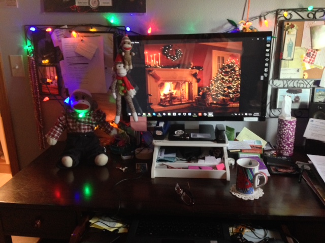 Sock Munkee with Christmas Decorations on desk